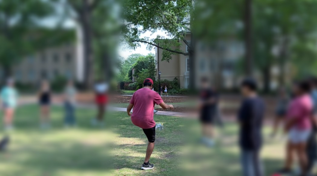 Students playing a Korean game outdoors on campus