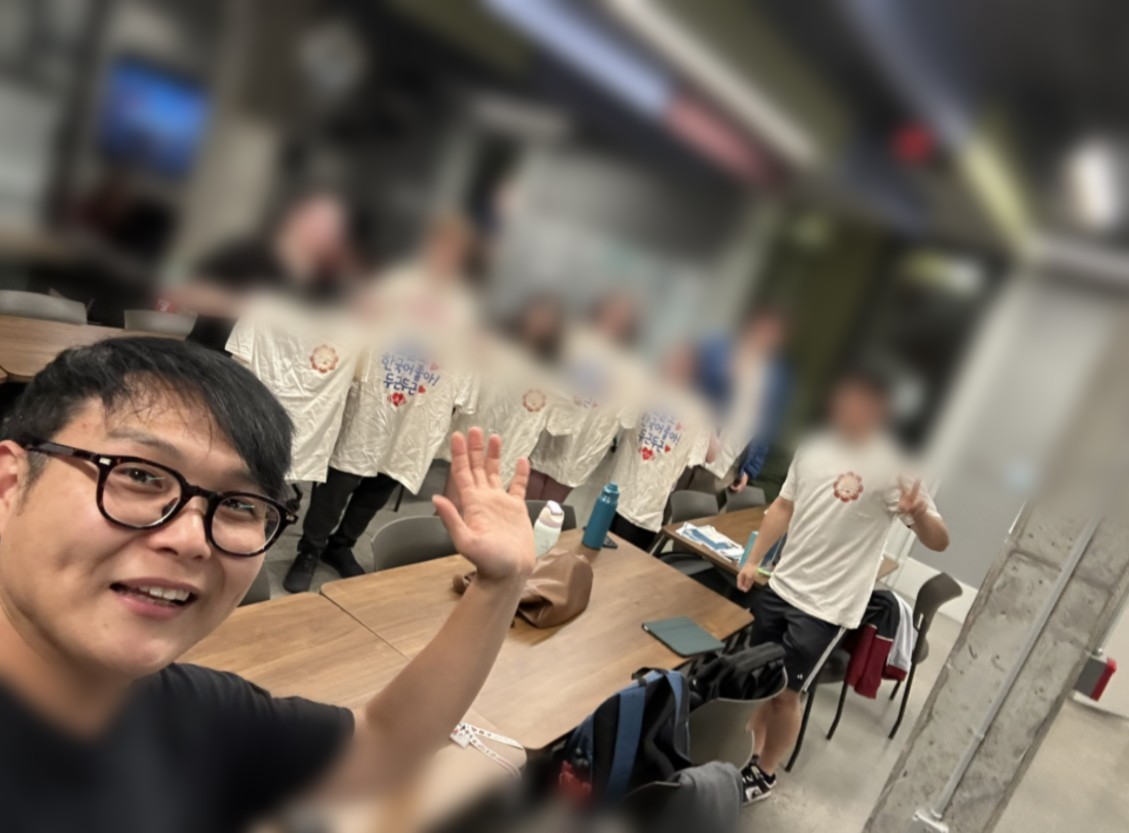 Students holding Korean Language Table shirts